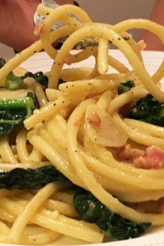 Kale and Bacon Carbonara Pasta Recipe - that is comfort food chessy dinner that is so easy to make. Grab eggs, cheese, bacon, and pasta. Happy Cooking. www.ChopHappy.com