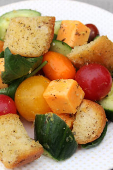 Garlic Bread Salad Recipe that is crunchy, sweet, and filled with Italian seasoning. Grab bread butter and garlic and make croutons. Then add tomato, basil, and all kinds of fresh veggies. This is a salas for weeknight fun. Happy cooking! www.ChopHappy.com #garlicbread #salad