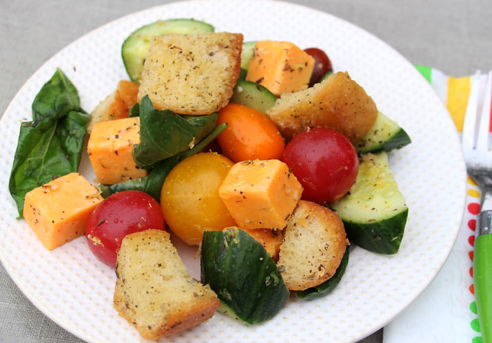 Garlic Bread Salad Recipe that is crunchy, sweet, and filled with Italian seasoning. Grab bread butter and garlic and make croutons. Then add tomato, basil, and all kinds of fresh veggies. This is a salas for weeknight fun. Happy cooking! www.ChopHappy.com #garlicbread #salad 