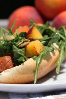 Summer Salad Hot Dog Recipe- that has a lemony sweet peach and peppery arugula salad on top! #comfortfood love! Happy Cooking! www.ChopHappy.com #hotdogrecipe #saladrecipe