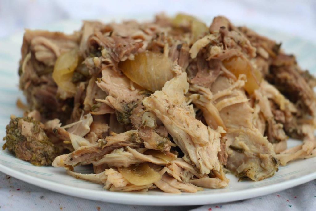 Slow Cooker Pulled Pork Recipe - that is magically amazing. You mix in the blender a pork pesto that you rub all over the pork. Add wine and you have a slow cooker success. www.ChopHappy.com
