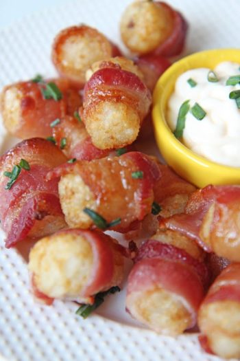 Honey Glazed Bacon Wrapped Tater Tots Recipe - is so comfort food decadent! This is so easy and it is baked. It is oven baked, we use frozen tater tots, and wrap it all in a yummy piece of #bacon. Hope you enjoy this quick #appetizer. www.ChopHappy.com