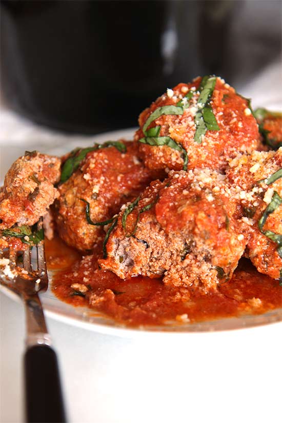 Slow Cooker Meatball Recipe - is the cheesy and easy way to get your family to have big smiles every bite. The key is ground beef, spices, fresh herbs (basil, parsley, and oregano, and 2 cheesy ingredients that make the meatballs super soft. Hope you love this recipe. www.ChopHappy.com