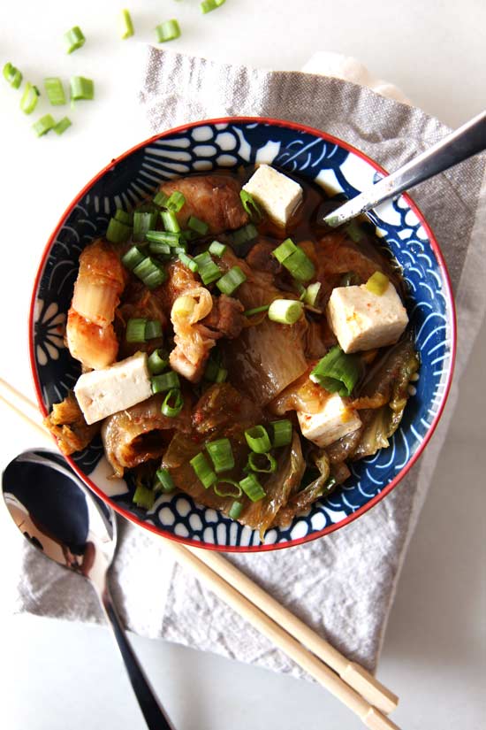 Slow Cooker Kimchi Soup Recipe- is a warm bowl of sweet and spicy comfort food hug. Perfect ways to use kimchi. Just drop ingredients in slow cooker and come home to warm dinner. www.ChopHappy.com