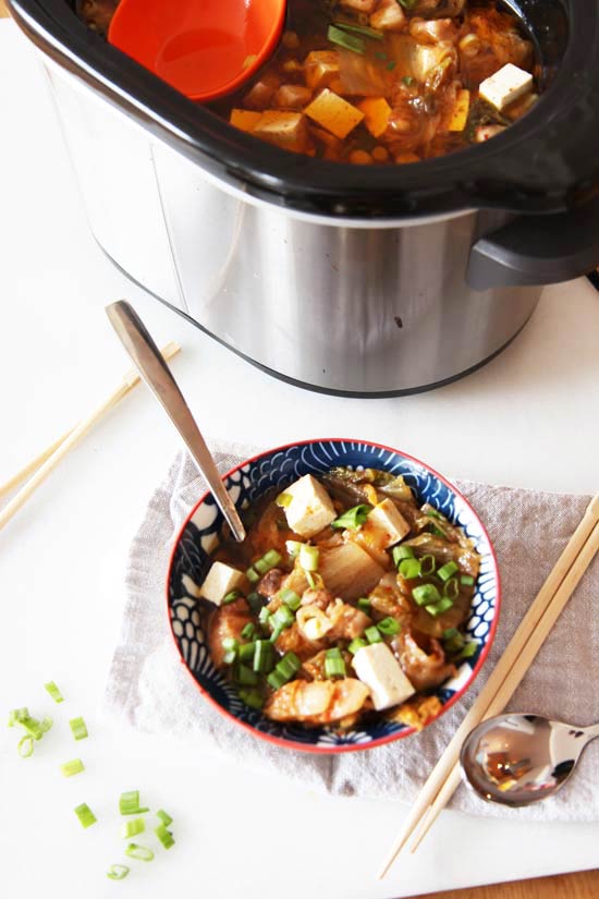 Slow Cooker Kimchi Soup Recipe- is a warm bowl of sweet and spicy comfort food hug. Just drop ingredients in slow cooker and come home to warm dinner. www.ChopHappy.com