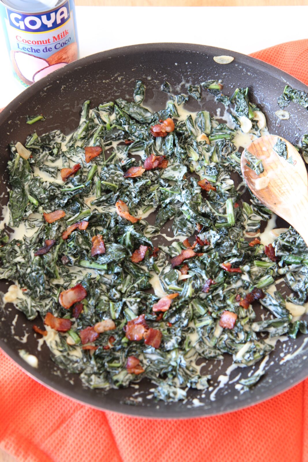Bacon Coconut Creamed Kale Recipe - that is creamy decadent comfort food you will crave. This recipe is so easy and is a one pot side dish. Ingredients include, bacon, coconut milk, kale, garlic, red pepper flakes, and apple cider vinegar. Happy comfort food cooking! www.ChopHappy.com
