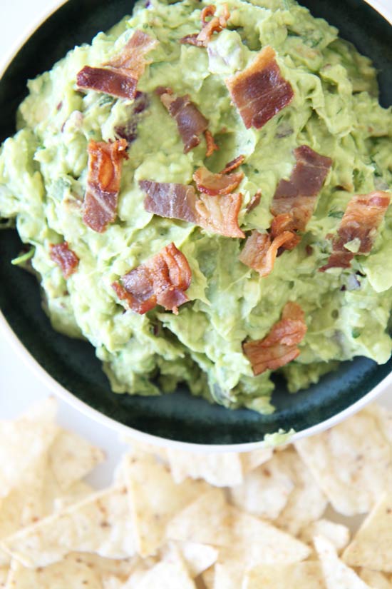 Bacon Guacamole Recipe - that is so creamy delicious you will not stop dipping. Grab avocados, vinegar, onion, and bacon. Happy appetizer making! www.ChopHappy.com