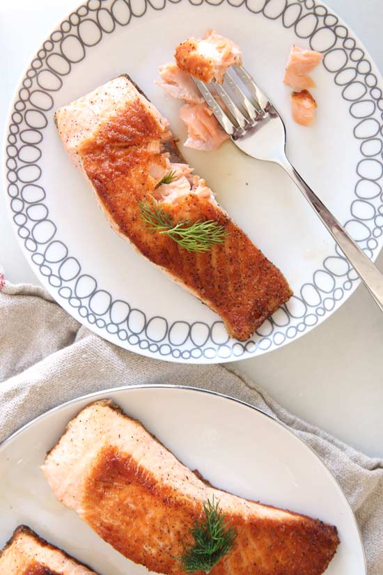 7 Minute Pan Seared Salmon Recipe that is the perfect weeknight #dinner. Every bite is crispy, flakey, and juicy yum. Happy Cooking. www.ChopHappy.com