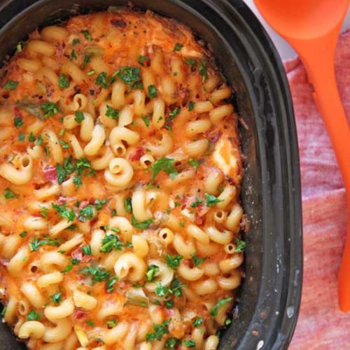 Slow Cooker Quesso Mac and Cheese Recipe. Grab your crock pot, pasta and cheese. This is the perfect dinner idea to come home to after a long day of work. A hot meal will be smiling at you! www.ChopHappy.com #macandcheese #slowcookerrecipes