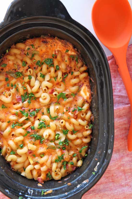 Slow Cooker Quesso Mac and Cheese Recipe. Grab your crock pot, pasta and cheese. This is the perfect dinner idea to come home to after a long day of work. A hot meal will be smiling at you! www.ChopHappy.com #macandcheese #slowcookerrecipes