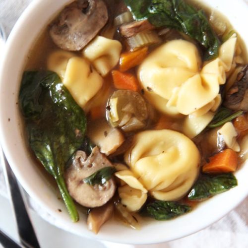 Simple Slow Cooker Tortellini Soup Recipe. The slow cooker is your personal chef. Drop chicken broth, veggies, and pasta and come home to warm easy dinner. www.ChopHappy.com #soup #slowcooker