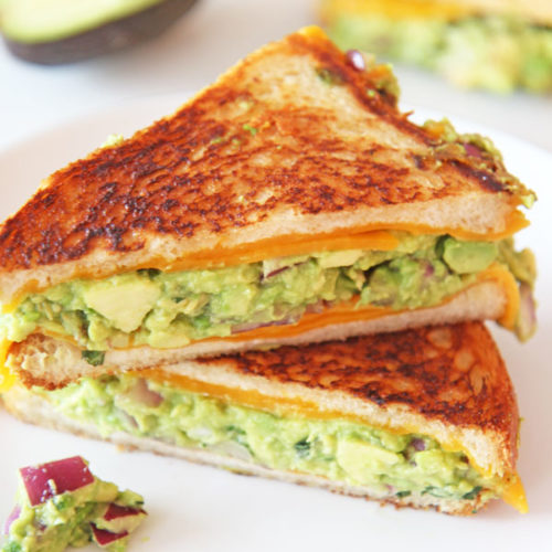 Guacamole Grilled Cheese Recipe. This is so easy to make for any weeknight dinner or fun lunch. Avocado, onions, mint, jalapeño, and vinegar make up the guacamole. Happy Cooking! #grilledcheese #guacamole