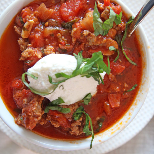30 Minute Italian Chili Recipe! Grab sweet and spicy Italian sausage and mix with crushed tomatoes, onion, garlic, oregano, red pepper flakes, garlic, basil, parsley, and water. This is the perfect comfort food weeknight dinner recipe. Happy Cooking! www.ChopHappy.com #chilirecipe #Italianrecipe
