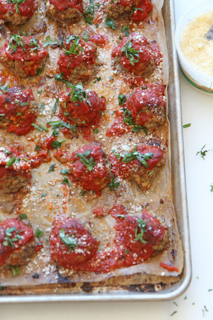 Sheet Pan Cheesy Meatball Recipe. Grab ground beef, ricotta (secret ingredient), parsley, basil, oregano, eggs, breadcrumbs, and marinara. This is an easy no mess weeknight recipe. Happy Cooking! www.ChopHappy.com #sheetpanrecipe #meatballs