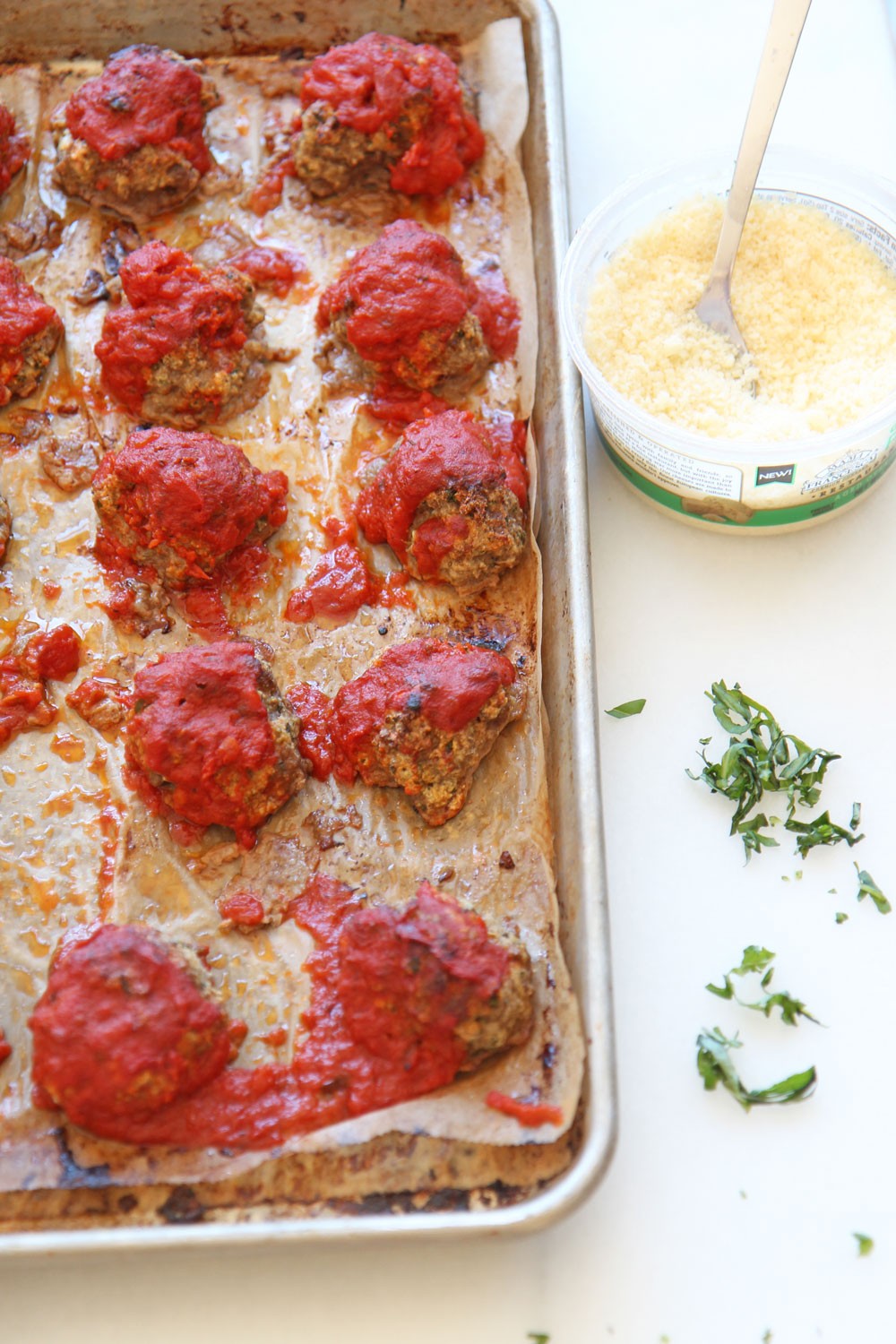 Sheet Pan Cheesy Meatball Recipe. Grab ground beef, ricotta (secret ingredient), parsley, basil, oregano, eggs, breadcrumbs, and marinara. This is an easy no mess weeknight recipe. Happy Cooking! www.ChopHappy.com #sheetpanrecipe #meatballs