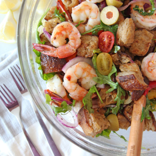 Shrimp and Garlic Bread Panzanella Salad. Grab day old sourdough bread, butter, juicy sheet pan shrimp, sweet tomatoes, and peppery arugula. This is the perfect salad for a crowd or healthy dinner. Happy Coking! www.ChopHappy.com #PanzanellaSalad #saladrecipe