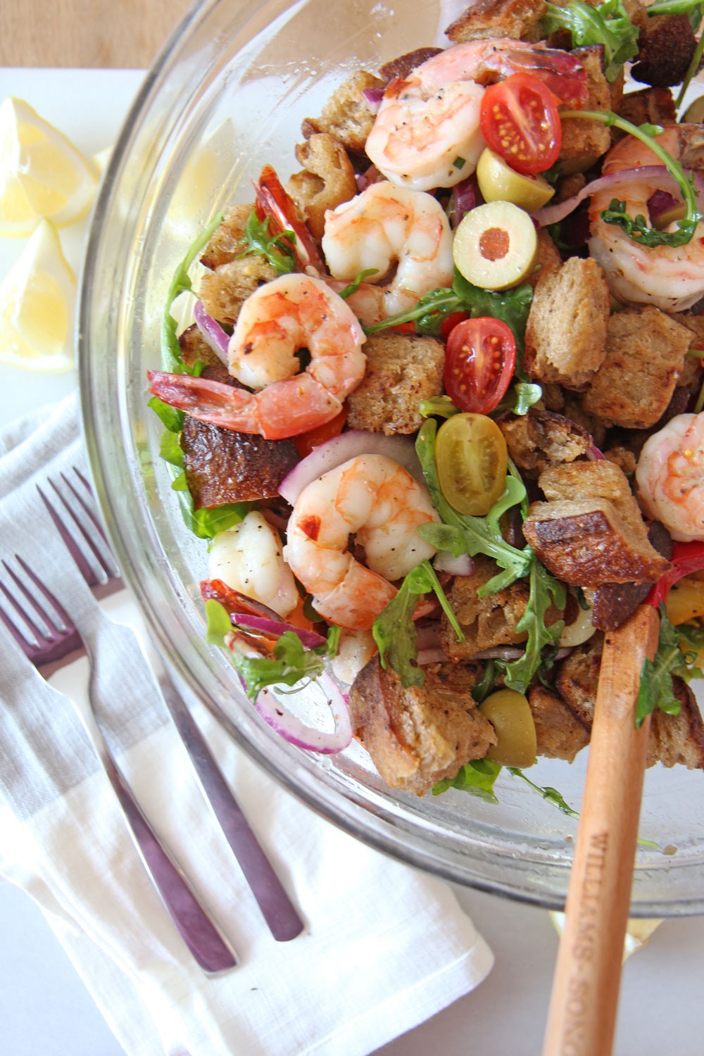 Shrimp and Garlic Bread Panzanella Salad. Grab day old sourdough bread, butter, juicy sheet pan shrimp, sweet tomatoes, and peppery arugula. This is the perfect salad for a crowd or healthy dinner. Happy Coking! www.ChopHappy.com #PanzanellaSalad #saladrecipe