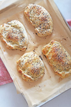 Everything Bagel Calzone Recipe. Grab ricotta cheese, lemon, smoked salmon, dill, scallions, and everything seasoning! This is a fun sheet pan dinner to celebrate you. Happy Cooking. www.chophappy.com #calzones #everythingbagelseasoning