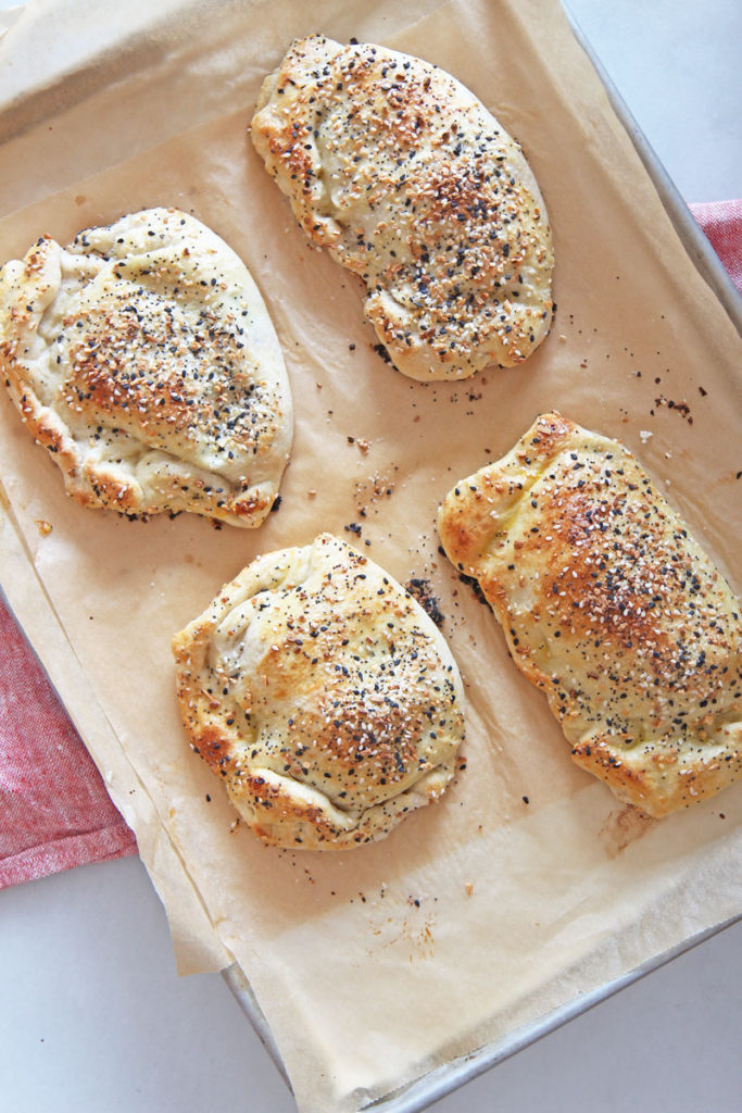 Everything Bagel Calzone Recipe. Grab ricotta cheese, lemon, smoked salmon, dill, scallions, and everything seasoning! This is a fun sheet pan dinner to celebrate you. Happy Cooking. www.chophappy.com #calzones #everythingbagelseasoning