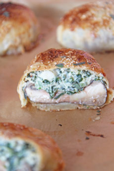 Stuffed Mushroom Wellington Recipe. Grab portabella mushrooms, spinach, cheese, and lots of herbs. This is my favorite holiday appetizer made into a puff pastry wrapped sheet pan dinner. Happy Cooking! #wellington #stuffedmushrooms
