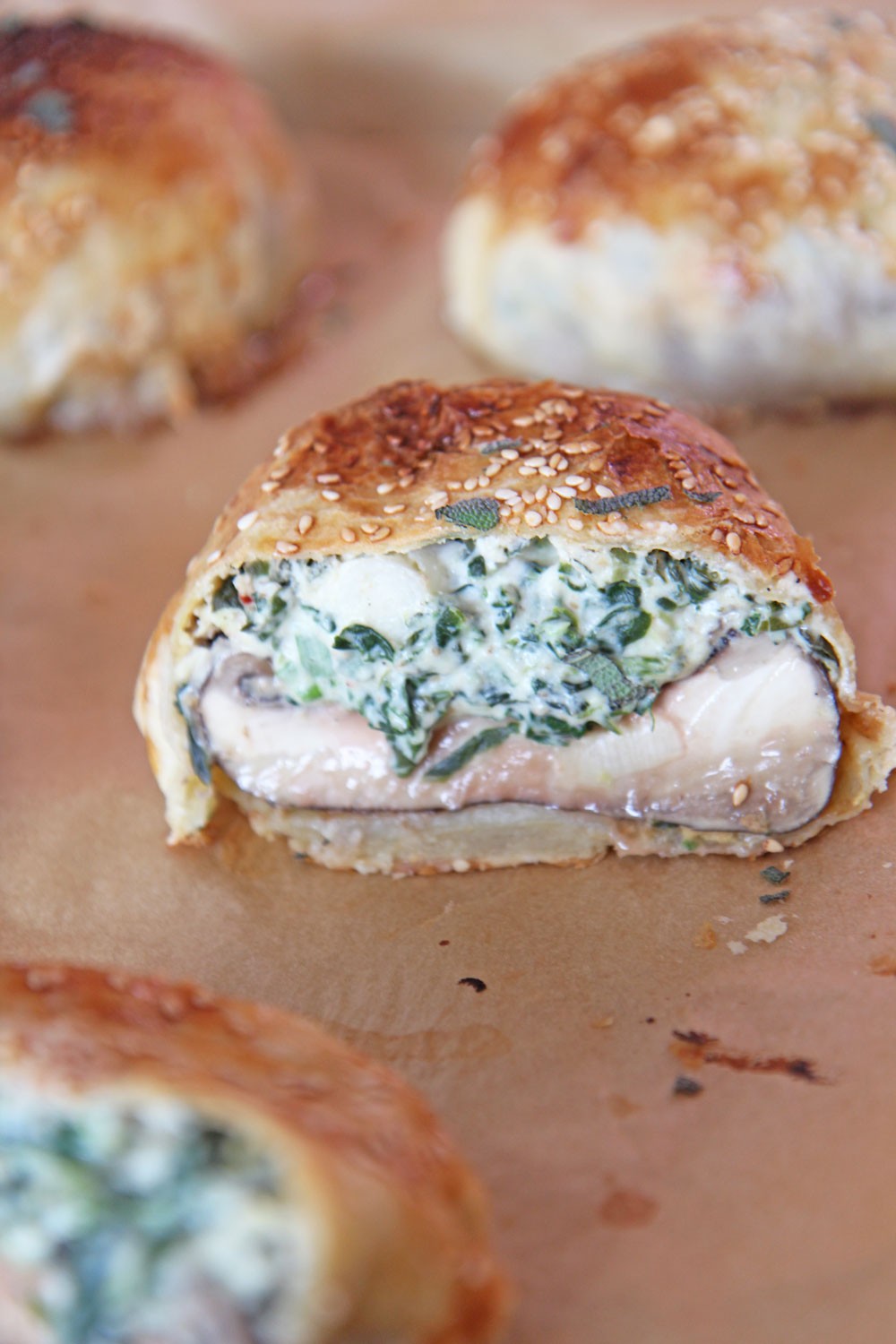 Stuffed Mushroom Wellington Recipe. Grab portabella mushrooms, spinach, cheese, and lots of herbs. This is my favorite holiday appetizer made into a puff pastry wrapped sheet pan dinner. Happy Cooking! #wellington #stuffedmushrooms 