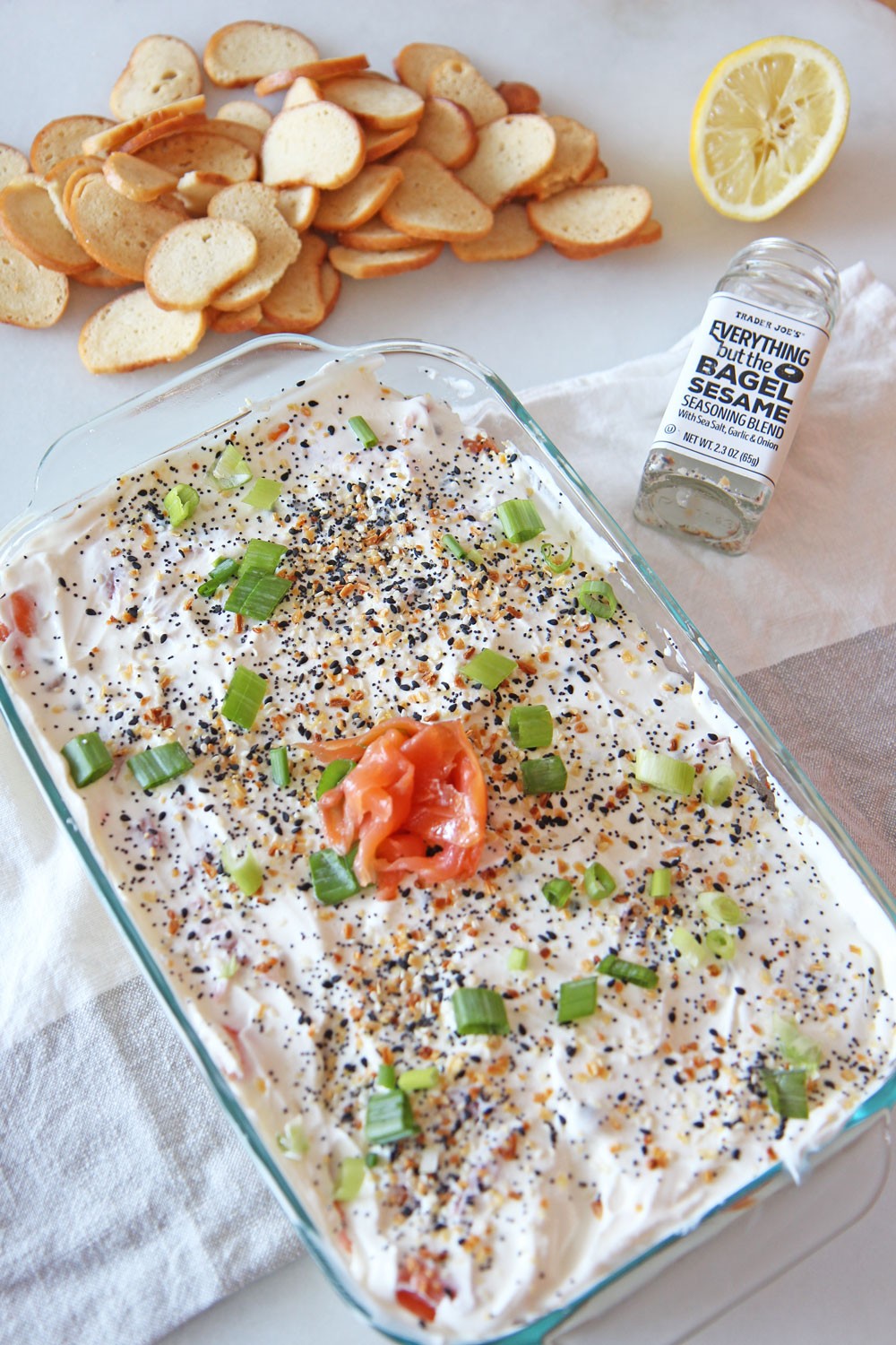 7 Layer Everything Bagel Dip Recipe. Perfect appetizer that tastes like a bagel and lox. Quick and easy starter that you can make a day in advance. Also a great host gift for the holidays. Happy Cooking! www.ChopHappy.com #everythingseasoning #7layerdip