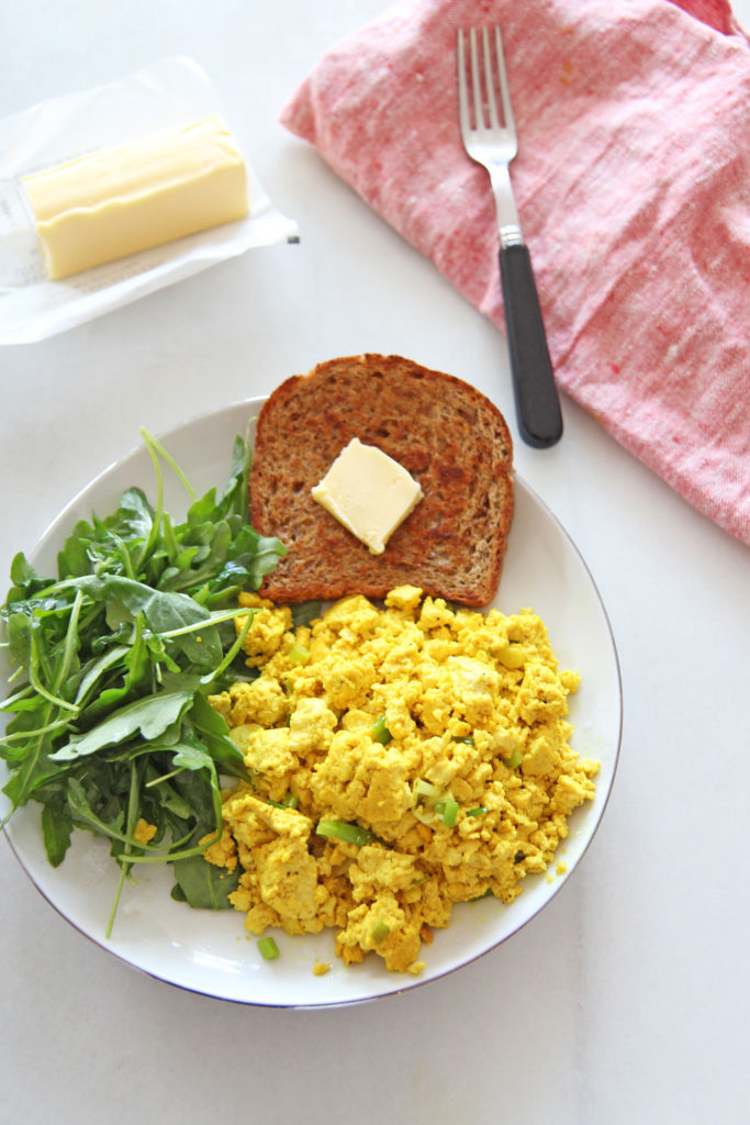 How To Make Scrambled Tofu (fast brunch idea). Grab tofu, butter, turmeric, mustard powder, and other seasonings. Happy Cooking! www.ChopHappy.com #tofu #veganrecipe