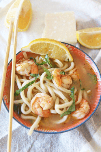 Shrimp Scampi Udon Noodle Soup Recipe. Simple 30 minte recipe that is one pot and comfort food yum. This is garlic, lemon, and chicken broth love mixed with udon noodles. Happy Cooking! www.ChopHappy.com #noodlesoup #shrimpscampi