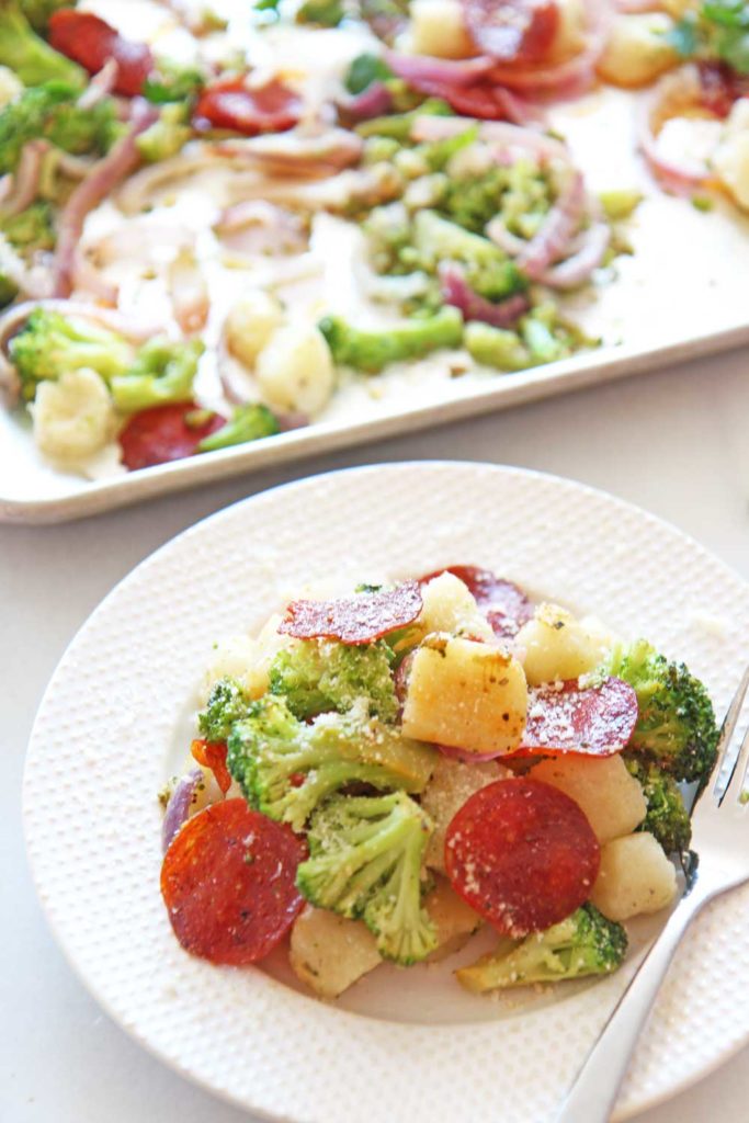 Sheet Pan Pepperoni Pizza Gnocchi Recipe. Frozen vegetables and frozen gnocchi cook on a sheet pan . This is a 20 minute recipe. Happy pasta pizza making! www.ChopHappy.com #pasta #pizza