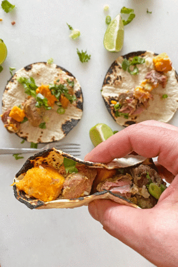 3 Ingredient Slow Cooker Pork and Sweet Potato Taco Recipe.This is a five ingredient dinner recipe that is ready when you get home from work. You can make this into tacos, burrito bowls, or soup if you add chicken broth. Happy Cooking! www.ChopHappy.com #slowcookertaco #porktaco