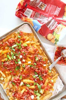 How to Transform Frozen Fries Into Loaded Taco Fries Recipe. Frozen fries, salsa, scallions, cheese, and chili seasoning. Transforming frozen fries is as easy as pantry seasonings cheese, and an oven. Happy sheet pan cooking! www.ChopHappy.com #frozenfries #nachos #pantry
