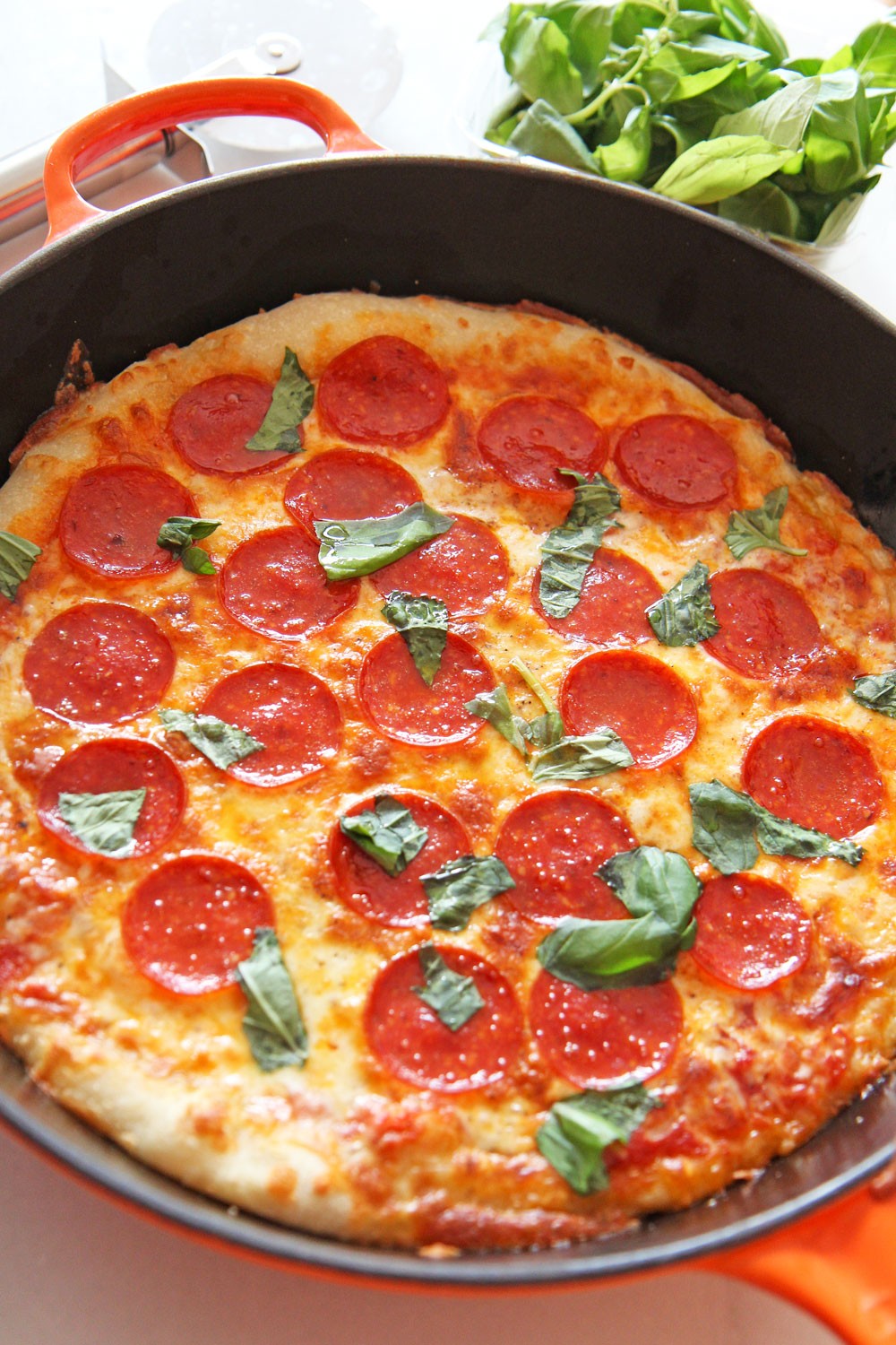 How to Make Pizza in a Cast Iron Pan. This is super easy. Just get pizza dough, marinara, mozzarella cheese, pepperoni, and basil. Pizza making is so easy and this tastes just like NYC pizza. Happy cooking! www.ChopHappy.com #howtomakepizza #pizza