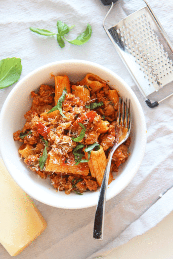 How To Make The Best Meat Sauce in Under 30 Minutes. Use pepperoni, Italian sausage, onions, and jarred marinara. www.ChopHappy.com #meatsauce #Bolognese