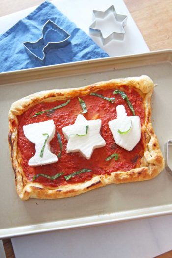 Hanukah Puff Pastry Pizza. Butter puff pastry with garlicky marinara, and mozzarella makes a festive holiday pizza! www.ChopHappy.com #HolidayRecipe #Hanukahrecipe