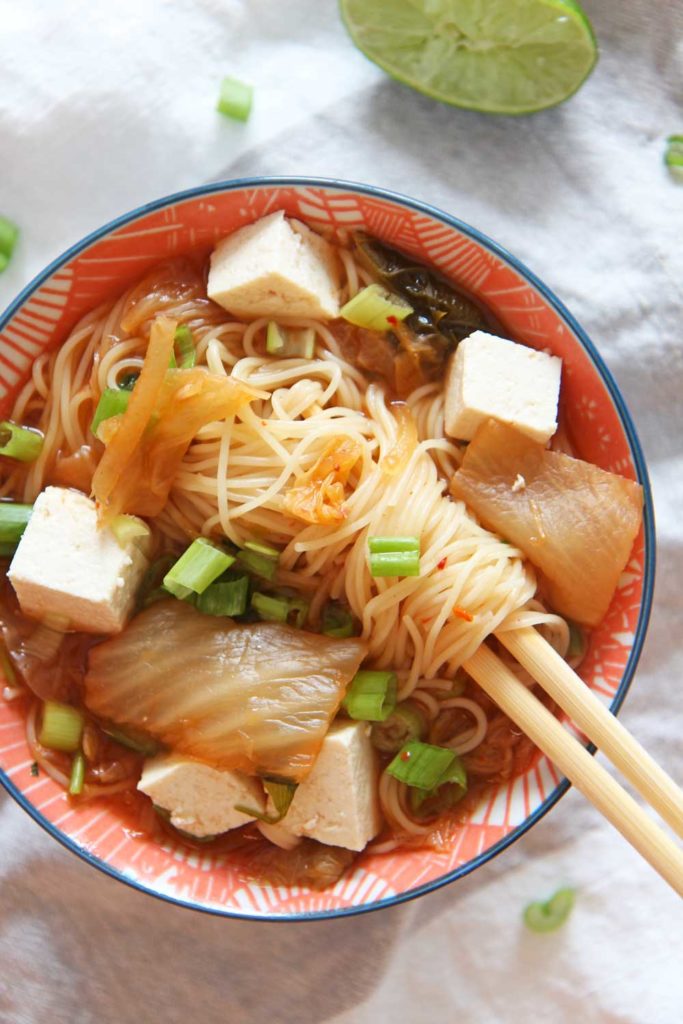 How to Make Kimchi Ramen Soup in a Slow Cooker. Grab noodles, tofu, kimchi, and scallions. Perfect soup that is all done in the crock pot. Happy Cooking! www.ChopHappy.com #souprecipe #ramenrecipe