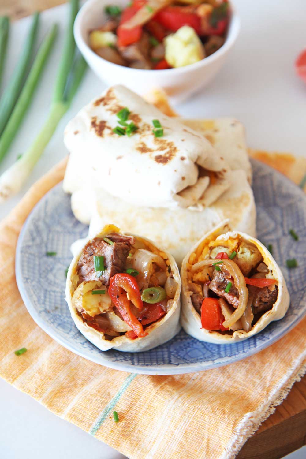 Leftover Breakfast Steak and Hash Brown Burrito Recipe. Use leftovers from dinner the night before to make an awesome brunch with a cheesy potato smile. Happy Cooking! www.ChopHappy.com #burritorecipe #breakfastBurrrito