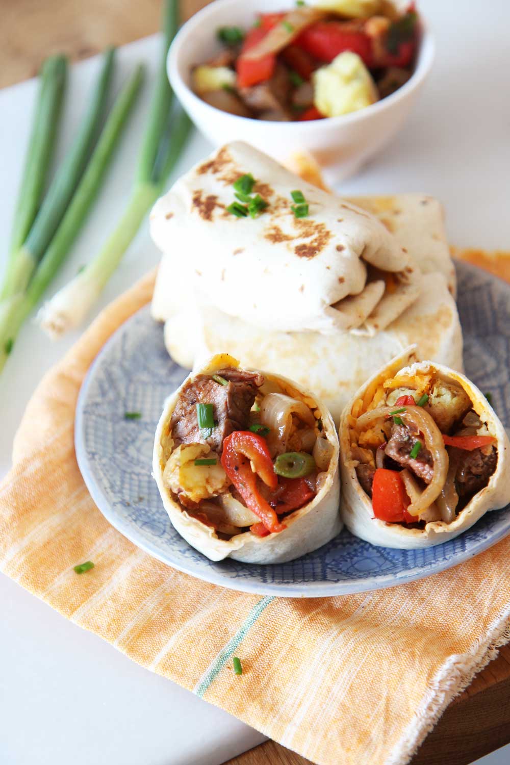 Leftover Breakfast Steak and Hash Brown Burrito Recipe. Use leftovers from dinner the night before to make an awesome brunch with a cheesy potato smile. Happy Cooking! www.ChopHappy.com #burritorecipe #breakfastBurrrito