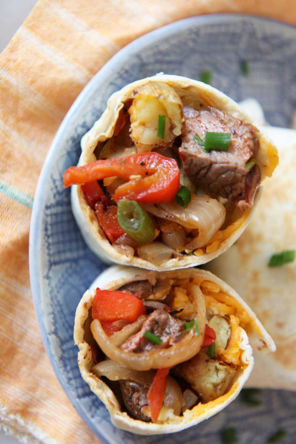 Leftover Breakfast Steak and Hash Brown Burrito Recipe. Use leftovers from dinner the night before to make an awesome brunch with a cheesy potato smile. Happy Cooking! www.ChopHappy.com #burritorecipe #breakfastBurrrito