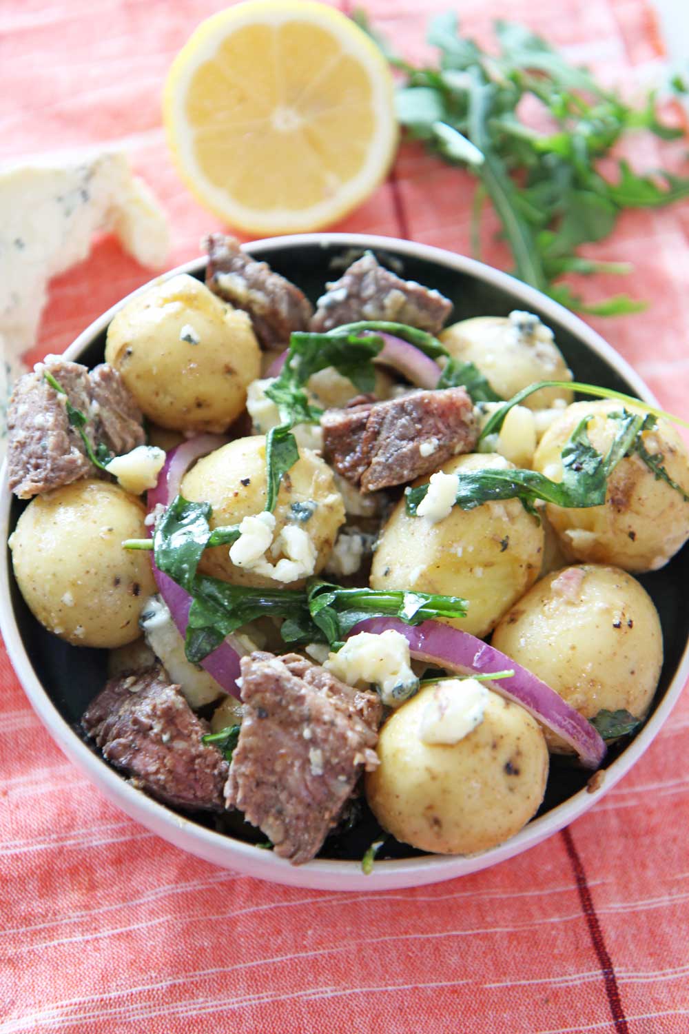Steakhouse Steak and Potato Salad. This is a 20 minute recipe for busy weeknightt dinner. NY strip steak and Yukon gold potatoes mix with blue cheese and peppery arugula! Perfect next day leftovers. #potatosalad #steakrecipe