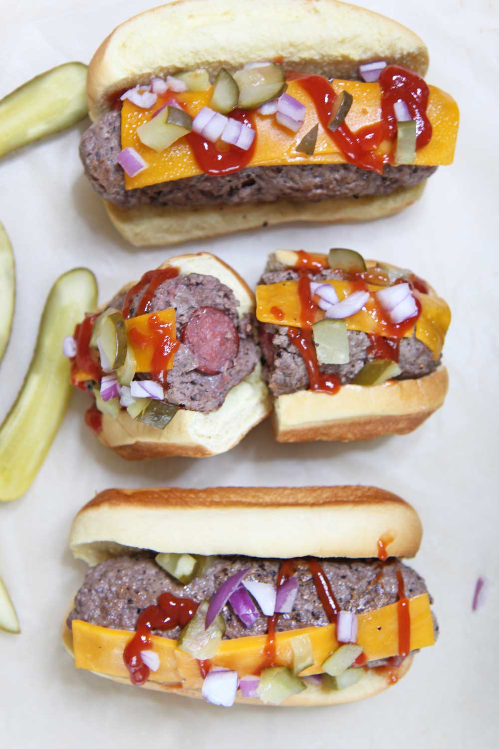 The Ultimate Burger Dog Food Hack. No more deciding weather to grill a hot dog or hamburger. This is a stuffed burger with a hot dog in the middle. Happy Grilling! #hotdog #foodhack