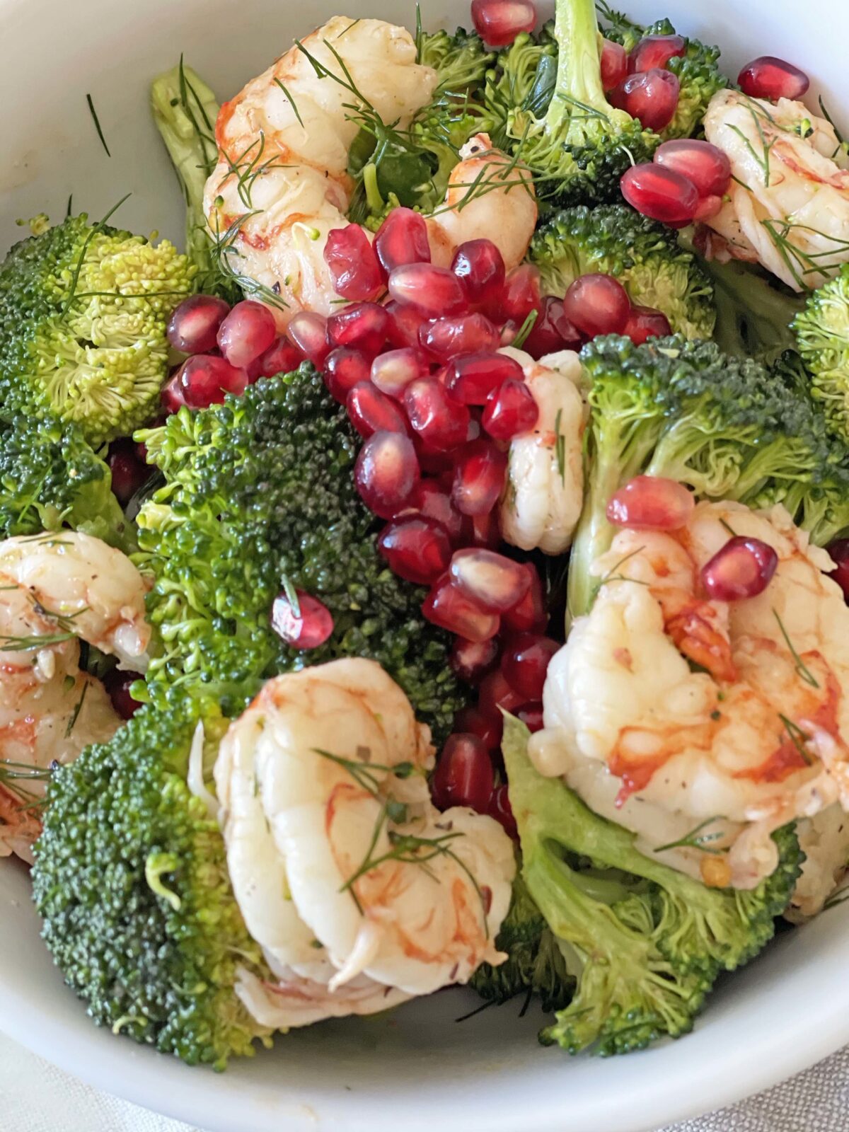 Easy Shrimp and Broccoli Salad. This is a perfect busy night dinner that has yummy leftovers. Broccoli, shrimp, pomegranates, Dijon mustard, and herbs. This is an easy Summer salad for a pool party. Happy Salad eating! www.ChopHappy.com #saladrecipe #broccolisalad