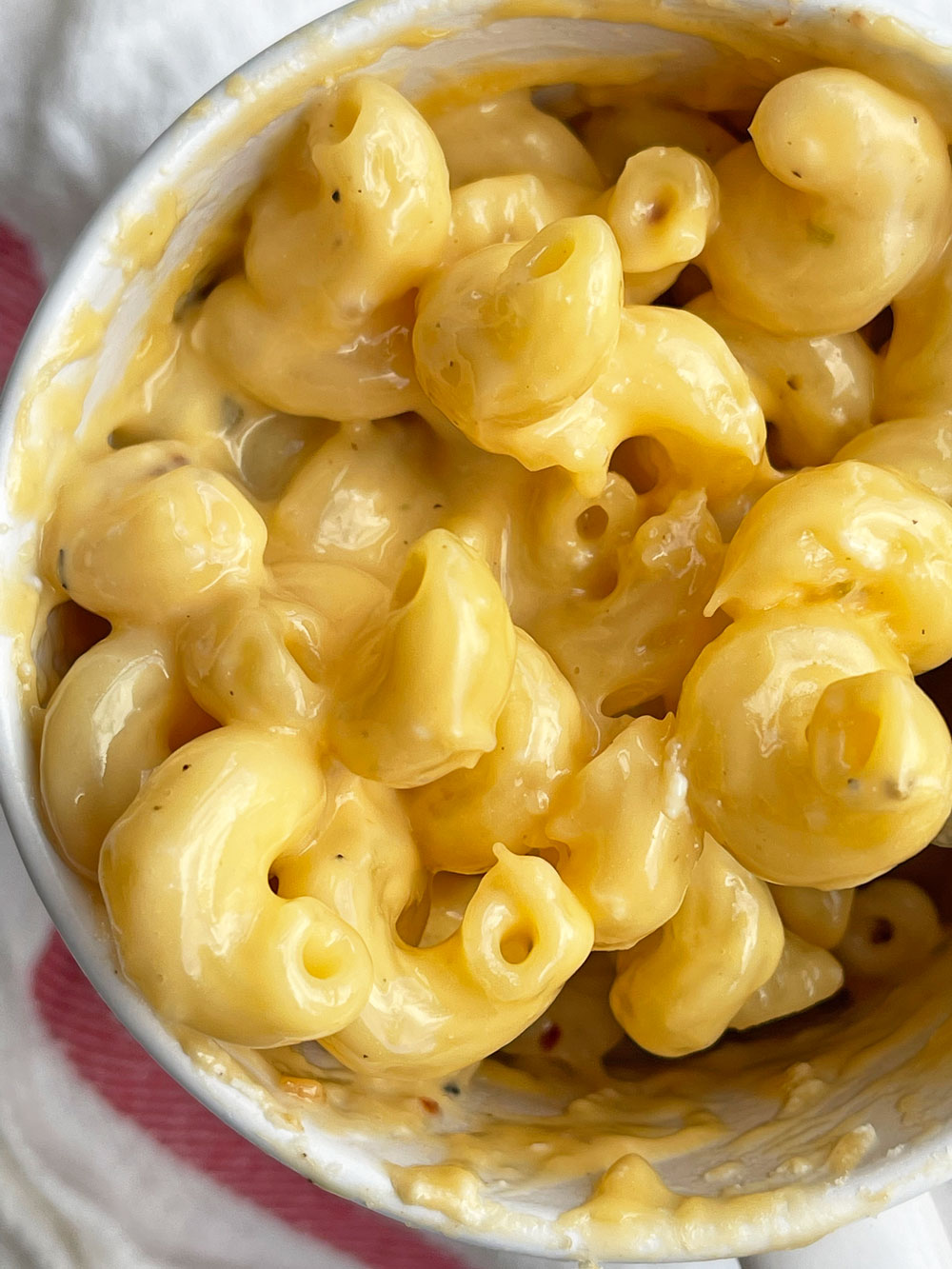 Microwave Mug Mac and Cheese. This is an easy recipe for midnight pasta cravings, easy dinner ideas, or someone who cooks for 1. Happy Pasta Making! www.ChopHappy.com #Macandcheesehack #mugmacandcheese