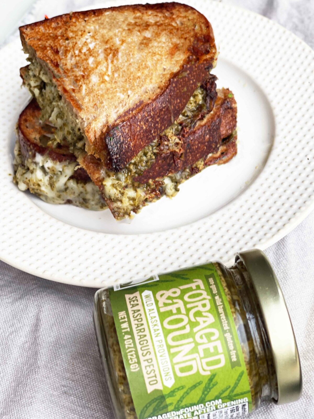 Pesto Grilled Cheese Recipe. This is an easy cheesy dinner idea for the perfect grilled cheese. Happy Cooking! www.ChopHappy.com #grilledcheese #pesto